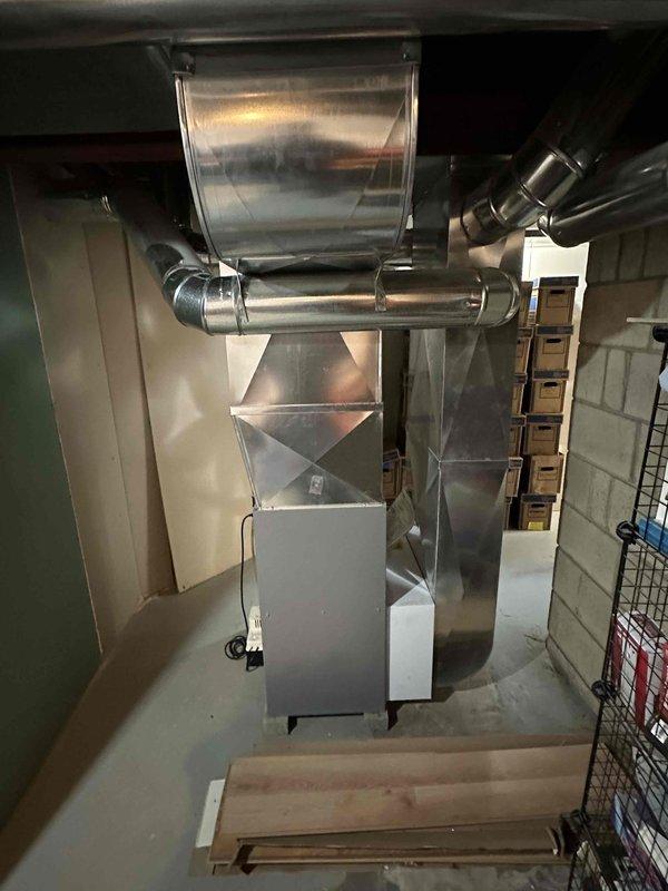 Conducted comprehensive evaluation of existing residential HVAC system for equipment replacement estimate. Assessed outdoor Lennox air conditioning condensing unit positioned on concrete pad against building exterior, noting current operational condition and installation configuration with refrigerant line sets penetrating through stone veneer wall. Inspected indoor components including furnace/air handler unit, plenum assembly, and ductwork transitions in basement utility area. Documented equipment specifications, system layout, and installation requirements. Photographed both outdoor condensing unit and indoor air handling components to support replacement proposal. Provided updated pricing and equipment options for complete system replacement.