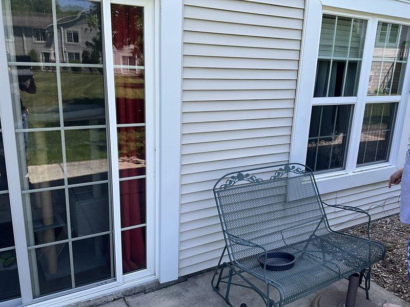 Conducted on-site assessment for mini split installation at residential property. Evaluated exterior wall locations and documented proposed installation areas including patio access points and exterior mounting surfaces on vinyl-sided structure for outdoor condenser unit placement and indoor air handler positioning.