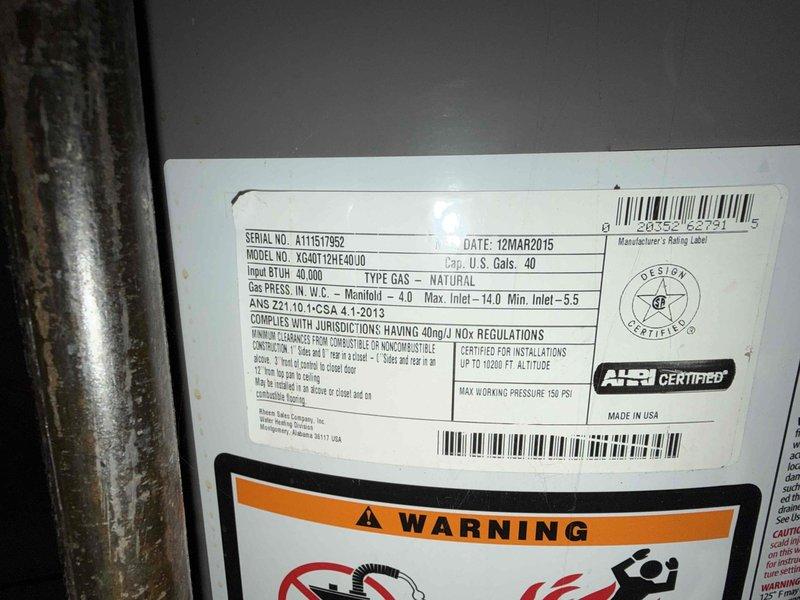 Completed installation estimate for a 50-gallon tall natural gas water heater with standard atmospheric venting. Documentation captured existing unit specifications showing 40,000 BTU input capacity with standard natural gas manifold pressure settings, along with verification of unit height measurements at approximately 60 inches to confirm proper clearance and venting requirements for replacement specifications.