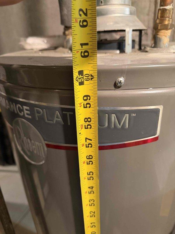 Completed installation estimate for a 50-gallon tall natural gas water heater with standard atmospheric venting. Documentation captured existing unit specifications showing 40,000 BTU input capacity with standard natural gas manifold pressure settings, along with verification of unit height measurements at approximately 60 inches to confirm proper clearance and venting requirements for replacement specifications.