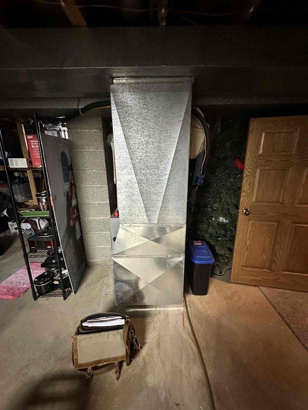 Conducted on-site evaluation for complete HVAC system replacement. Assessed existing outdoor condensing unit showing severe corrosion and rust damage on cabinet housing, with model number SC16020U109232 documented. Inspected indoor ductwork system in basement area, noting rigid insulation board construction extending floor to ceiling. Provided comprehensive replacement estimate covering complete system removal and installation of new equipment to address aging infrastructure and deteriorated components.