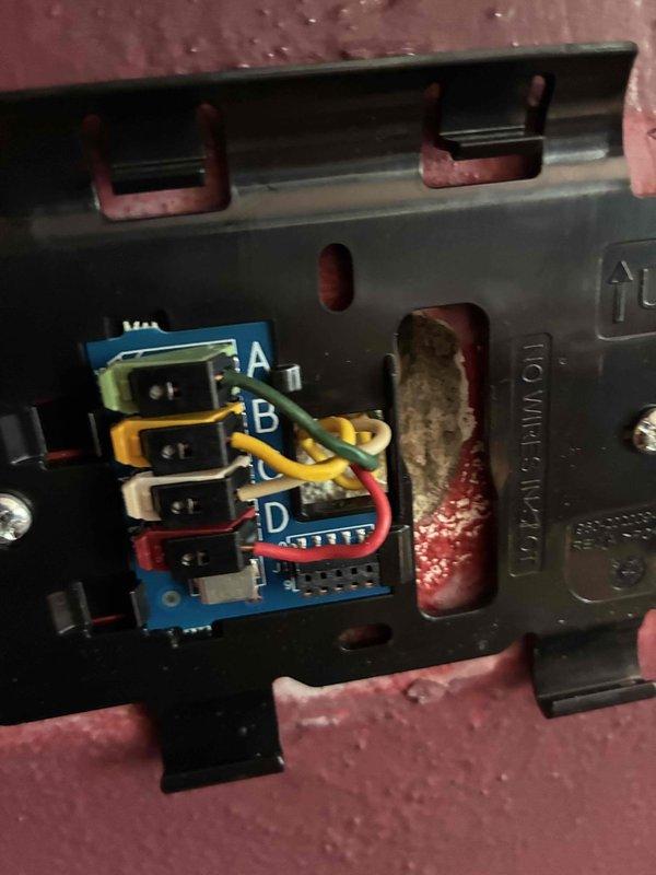 Responded to no cooling call where air conditioning system was not communicating with newly installed thermostat. Upon arrival, inspected outdoor condensing unit and indoor control board connections. Found thermostat wiring improperly connected at air handler control board terminals. Verified wire designations at terminal strip (A, B, C, D positions) and reconnected thermostat communication wires to appropriate terminals on control board. Tested system operation and confirmed proper communication between thermostat and equipment. System now cycling normally with thermostat commanding unit on and off as designed.
