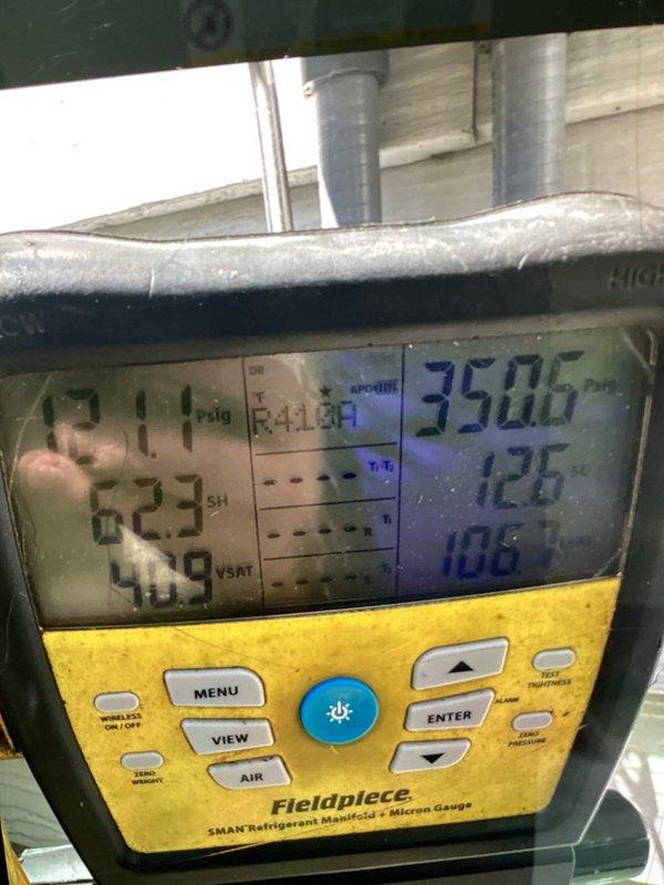 Performed comprehensive furnace and air conditioning tune-up at residential property. Connected Fieldpiece SMAN refrigerant manifold and micron gauge to outdoor condensing unit to verify R410A system pressures and performance metrics, with readings indicating 211 psig suction and 223 psig discharge pressures within acceptable operating range. Completed standard maintenance procedures including refrigerant charge verification, electrical component inspection, and system operational testing to ensure optimal heating and cooling performance for the upcoming season.