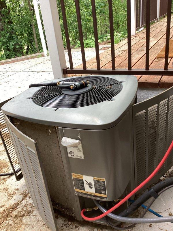Responded to no cooling complaint on residential air conditioning system. Upon arrival, found outdoor condenser unit with significant debris accumulation in and around equipment, restricting airflow to coil. Performed diagnostic evaluation and cleared accumulated leaves, twigs, and organic matter from unit perimeter and between equipment and deck structure. Inspected refrigerant lines, electrical connections, and condenser operation. Unit restored to proper cooling operation after removing airflow restrictions and verifying system performance.