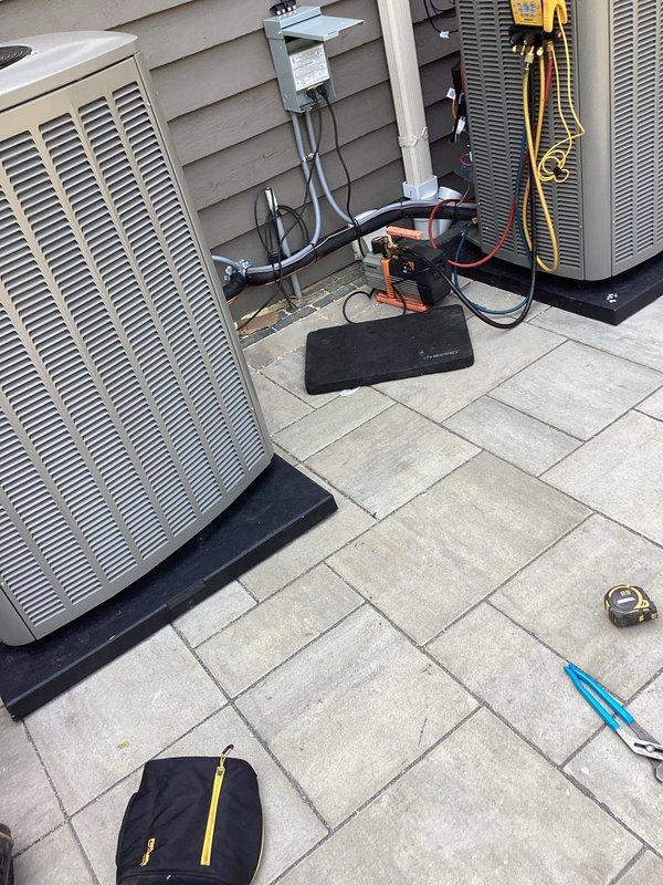 # HVAC Installation Summary

Completed installation of dual HVAC system including two outdoor condensing units and two Lennox furnace units with matching evaporator coils.

# Work Performed

**Outdoor Installation:**
Installed two condensing units on concrete paver patio area with proper vibration isolation pads. Mounted electrical disconnect boxes on exterior wall with appropriate conduit routing. Established refrigerant line sets connecting outdoor units to indoor coil assemblies. Completed electrical connections from disconnect boxes to condensing units per manufacturer specifications and local electrical code requirements.

**Indoor Installation:**
Installed two Lennox furnace units in basement mechanical room on concrete floor. Positioned units side-by-side for efficient space utilization and serviceability. Integrated matching evaporator coils with furnace cabinets. Connected supply and return air ductwork to units with proper sealing at all joints. Installed white PVC condensate