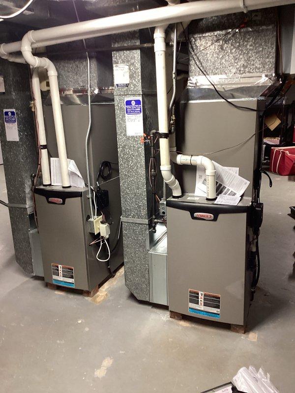 # HVAC Installation Summary

Completed installation of dual HVAC system including two outdoor condensing units and two Lennox furnace units with matching evaporator coils.

# Work Performed

**Outdoor Installation:**
Installed two condensing units on concrete paver patio area with proper vibration isolation pads. Mounted electrical disconnect boxes on exterior wall with appropriate conduit routing. Established refrigerant line sets connecting outdoor units to indoor coil assemblies. Completed electrical connections from disconnect boxes to condensing units per manufacturer specifications and local electrical code requirements.

**Indoor Installation:**
Installed two Lennox furnace units in basement mechanical room on concrete floor. Positioned units side-by-side for efficient space utilization and serviceability. Integrated matching evaporator coils with furnace cabinets. Connected supply and return air ductwork to units with proper sealing at all joints. Installed white PVC condensate