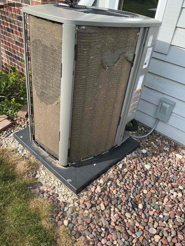 # HVAC Maintenance Summary

Completed routine cooling system maintenance visit under membership agreement. Performed comprehensive A/C tune-up on outdoor condensing unit, which exhibited heavy dirt and debris accumulation on condenser coils requiring thorough cleaning to restore optimal heat transfer efficiency and system performance.

# Detailed Work Performed

Arrived on-site and conducted visual inspection of outdoor air conditioning condensing unit positioned on residential property exterior. Unit accessed by opening front service panel to evaluate internal components and overall system condition.

**Primary Findings:**
- Condenser coils displayed significant accumulation of dirt, dust, and debris buildup
- Heavy soiling observed with thick brownish material covering substantial portions of coil surface
- Left and center coil sections showed particularly dense contamination
- Dark discoloration in multiple areas indicating prolonged dirt accumulation
- Restricted airflow conditions