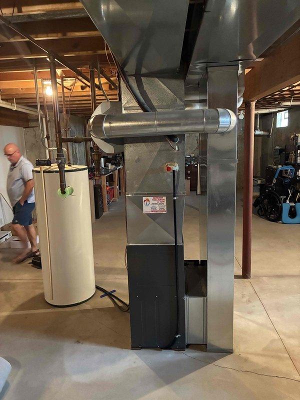 Conducted comprehensive HVAC system evaluation for aging 24-year-old air conditioning unit located in basement mechanical room. Assessed existing furnace/air handler configuration, ductwork connections, and overall system condition to provide replacement recommendations. Documented current equipment specifications and spatial requirements for future system upgrade.