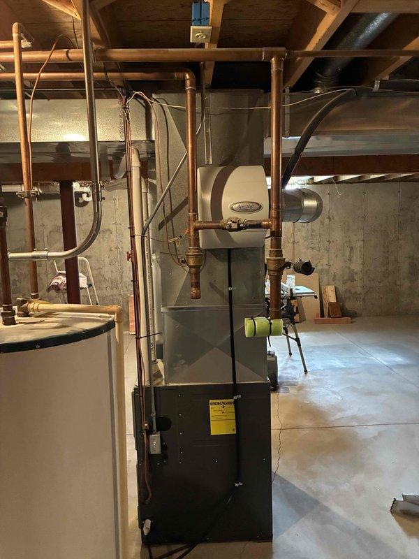 Conducted comprehensive HVAC system evaluation for aging 24-year-old air conditioning unit located in basement mechanical room. Assessed existing furnace/air handler configuration, ductwork connections, and overall system condition to provide replacement recommendations. Documented current equipment specifications and spatial requirements for future system upgrade.