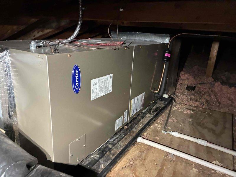 Completed routine cooling season maintenance visit as part of residential HVAC membership agreement. Performed comprehensive system inspection of split-system air conditioning unit, including outdoor Carrier condenser unit and attic-mounted air handler. Connected refrigerant manifold gauges to verify proper system pressures and refrigerant charge levels. Inspected condenser fan operation, electrical connections, and overall unit condition at outdoor location. Accessed attic space to service air handler unit, checking blower assembly, condensate drainage, and ductwork connections. Replaced air filter with customer-provided 20x25x6 media filter. All components operating within manufacturer specifications with no deficiencies noted.