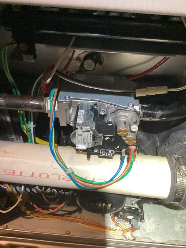 Responded to gas leak tagged by utility company. Upon arrival, inspected furnace gas valve assembly and associated connections. Verified gas valve operation, checked all wire connections to valve assembly, and examined PVC condensate piping and mounting hardware. Performed thorough visual inspection of burner compartment, heat exchanger area, and all gas piping connections. Documented equipment condition with photos showing gas valve, electrical connections, and internal furnace components in proper working order.