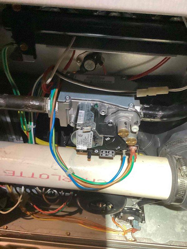 Responded to gas leak tagged by utility company. Upon arrival, inspected furnace gas valve assembly and associated connections. Verified gas valve operation, checked all wire connections to valve assembly, and examined PVC condensate piping and mounting hardware. Performed thorough visual inspection of burner compartment, heat exchanger area, and all gas piping connections. Documented equipment condition with photos showing gas valve, electrical connections, and internal furnace components in proper working order.