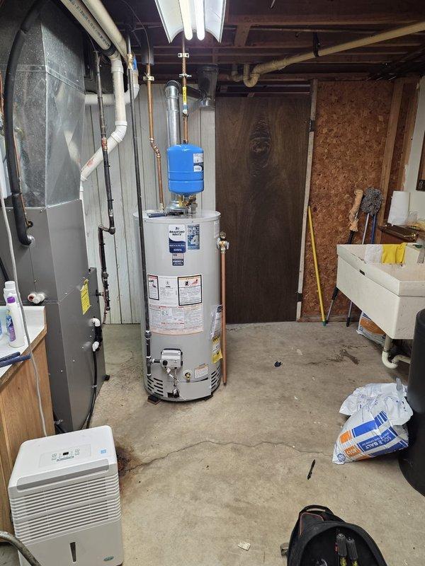 Installed Bradford White 40-gallon natural gas water heater, Model RG240S6N, in basement mechanical room. Connected all water supply lines, gas piping, and venting per manufacturer specifications and local code requirements. Verified proper operation, tested temperature and pressure relief valve, and ensured all connections were secure and leak-free.