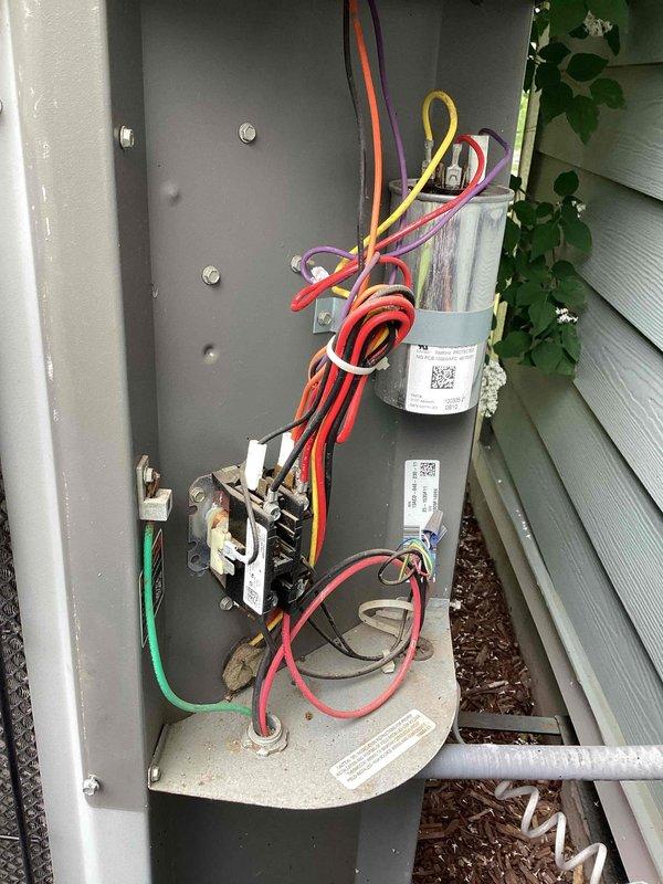 Completed annual tune-up on residential HVAC system. Inspected evaporator coil assembly and noted significant dirt and debris accumulation affecting airflow efficiency; cleaned coil face and protective grid. Inspected outdoor electrical disconnect panel, verified all electrical connections, tested contactor operation, and confirmed capacitors are functioning within specifications. Customer expressed interest in maintenance agreement options and requested follow-up information.