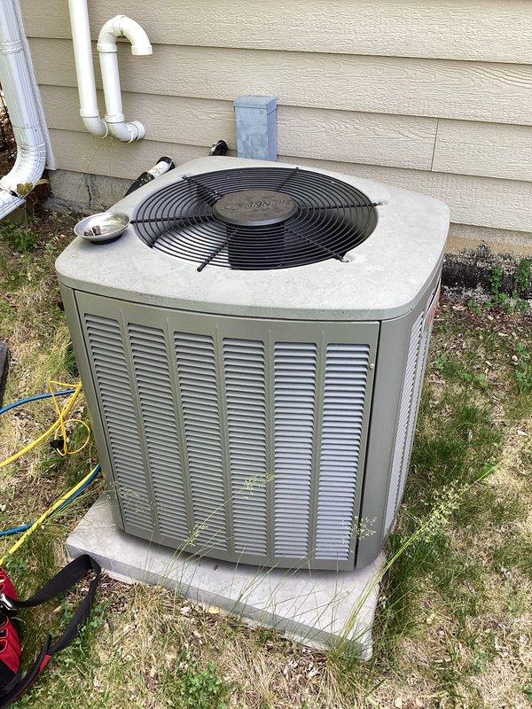 Responded to service call for Goodman air conditioning unit experiencing intermittent operation and unusual noises. Upon arrival, performed comprehensive diagnostic inspection of outdoor condenser unit, including examination of fan assembly, motor components, and electrical connections. Documented equipment condition with photographs showing unit placement on concrete pad and detailed views of fan guard assembly. Completed troubleshooting to identify source of concerning sounds and intermittent cycling issues.
