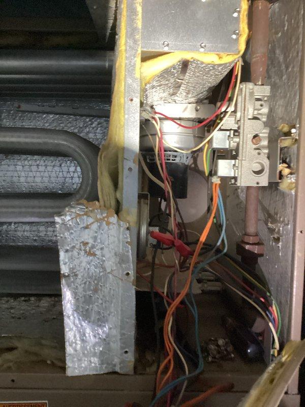 # HVAC Tune-Up Service Completed

Performed comprehensive tune-up on MagicPak combination heating and cooling unit. Inspection revealed ice buildup on internal bracket component and evaporator coil assembly showing signs of oxidation and discoloration. Completed standard maintenance protocol including visual inspection of heat exchanger coils, electrical connections, and control board wiring. Documented unit condition with photographic evidence showing serpentine coil configuration, insulation integrity, and overall system components for service records.