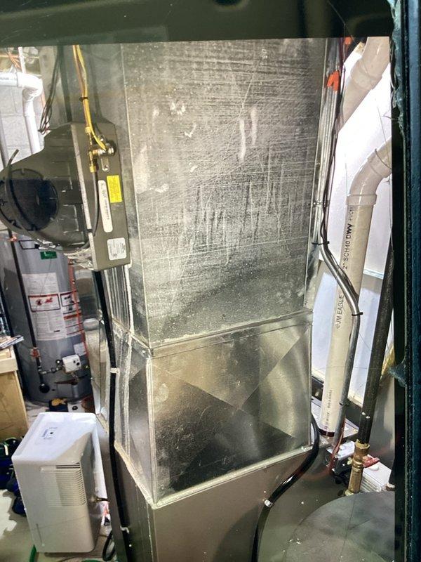 Responded to no cooling complaint on Lennox HVAC system with outdoor unit running but no cool air delivery. Performed diagnostic evaluation of indoor air handler and furnace assembly located in basement mechanical room. Inspected refrigerant lines, condensate system, and blower motor operation to identify cause of cooling failure and determine necessary repairs.
