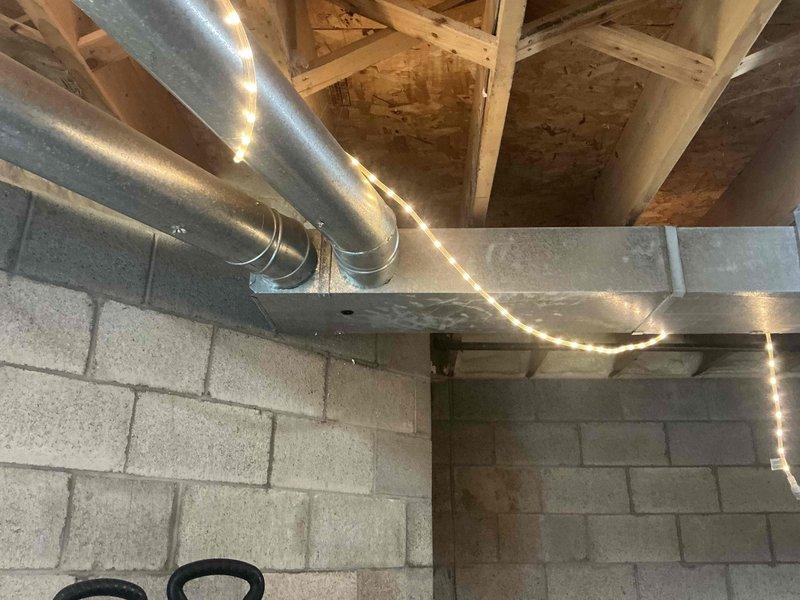 Conducted comprehensive estimate for complete HVAC system replacement including 40-year-old furnace, air conditioning unit, and aging 40-50 gallon gas water heater with upgrade to larger capacity tank. Evaluated existing ductwork configuration and zoning system for potential reconfiguration of dampers and zone controls to improve system efficiency and comfort distribution throughout the property. Assessed basement mechanical room layout and existing infrastructure to determine optimal equipment placement and integration requirements for new system installation.