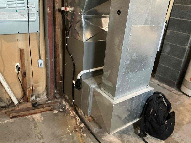 Responded to emergency AC service call and conducted comprehensive system evaluation in basement mechanical room. Assessed existing furnace, air handler unit, ductwork configuration, and associated HVAC components to provide replacement estimate. Documented current equipment condition, noting galvanized metal ductwork system, electrical connections, and overall installation layout for equipment replacement planning.
