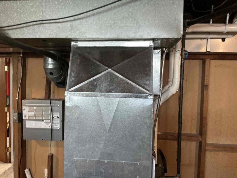 Responded to emergency AC service call and conducted comprehensive system evaluation in basement mechanical room. Assessed existing furnace, air handler unit, ductwork configuration, and associated HVAC components to provide replacement estimate. Documented current equipment condition, noting galvanized metal ductwork system, electrical connections, and overall installation layout for equipment replacement planning.