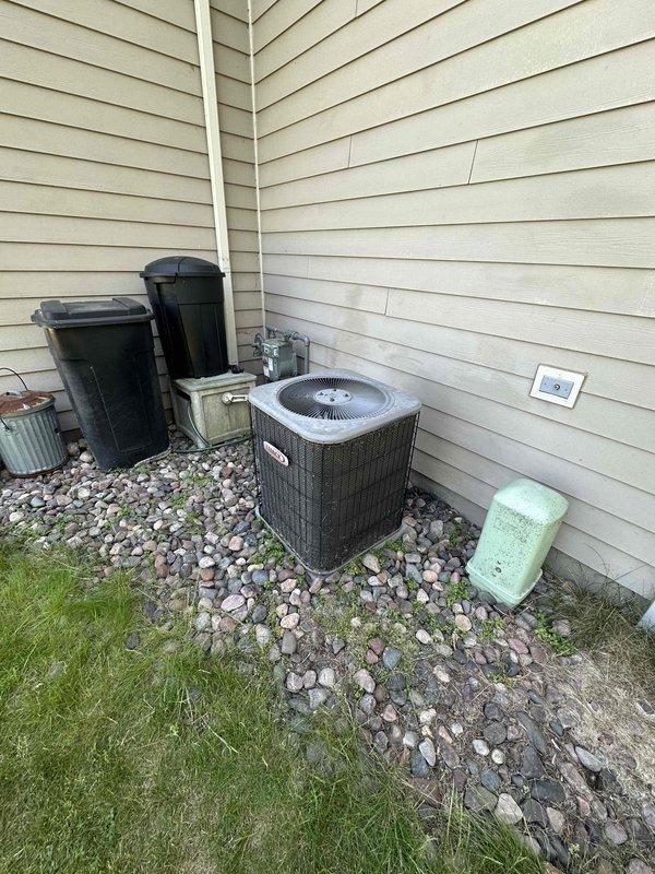 Provided estimate for complete HVAC system replacement including air conditioning unit and natural gas furnace located in basement. Upon inspection, discovered rodent damage to electrical wiring rendering the AC unit inoperable. Documented existing outdoor condenser unit with protective mesh cage and indoor furnace equipment for replacement specifications.