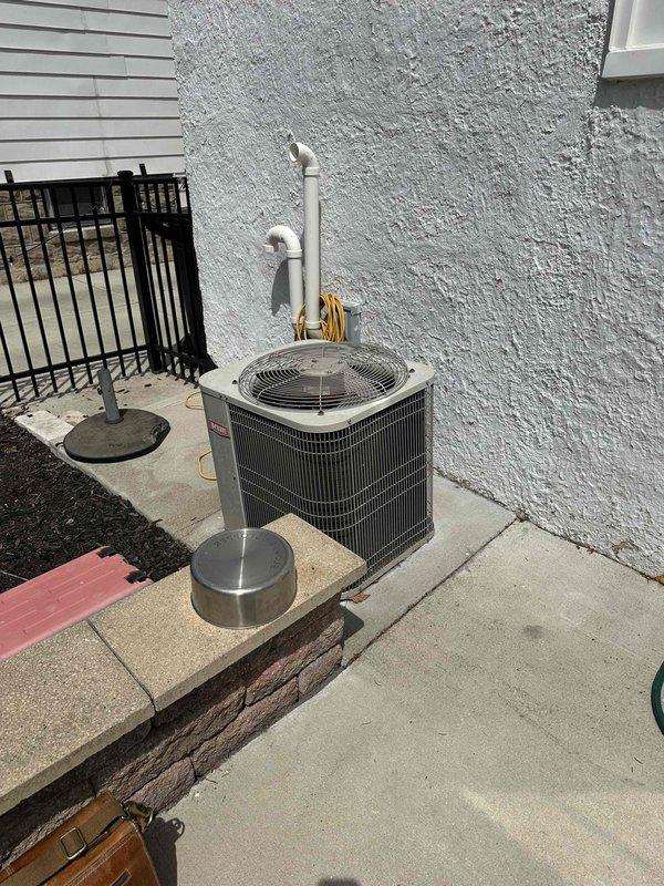 Conducted comprehensive site assessment for complete HVAC system replacement in residential basement location. Evaluated existing furnace unit with deteriorated components and outdoor air conditioning condenser positioned on concrete pad against exterior wall. Documented current equipment specifications, ductwork configuration, and installation parameters including PVC condensate drainage and electrical connections. Provided detailed replacement estimate for new furnace and AC system, accounting for existing infrastructure modifications and proper sizing requirements based on home heating and cooling load calculations.