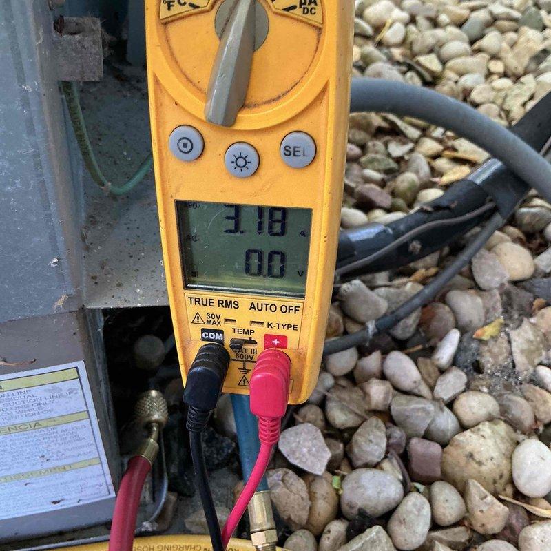 Completed annual air conditioning tune-up and system performance evaluation. Measured refrigerant pressures using manifold gauge set and verified temperature differential across the evaporator coil with digital multimeter, confirming proper system operation and refrigerant charge levels within manufacturer specifications.
