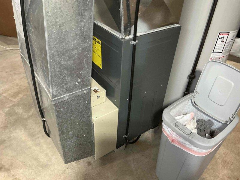 Responded to service call for non-operational air conditioning system. Conducted on-site assessment of existing HVAC equipment in basement mechanical room, including furnace unit with associated ductwork and refrigerant lines. Documented current system configuration through photographic documentation, noting aged galvanized ductwork with dust accumulation and existing copper refrigerant line installation. Prepared comprehensive replacement estimate for customer review covering complete system replacement requirements.