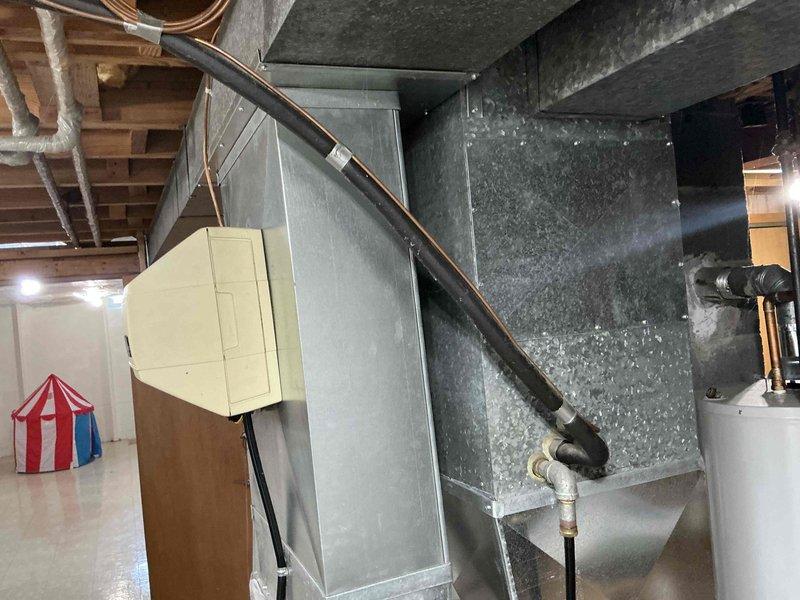Responded to service call for non-operational air conditioning system. Conducted on-site assessment of existing HVAC equipment in basement mechanical room, including furnace unit with associated ductwork and refrigerant lines. Documented current system configuration through photographic documentation, noting aged galvanized ductwork with dust accumulation and existing copper refrigerant line installation. Prepared comprehensive replacement estimate for customer review covering complete system replacement requirements.
