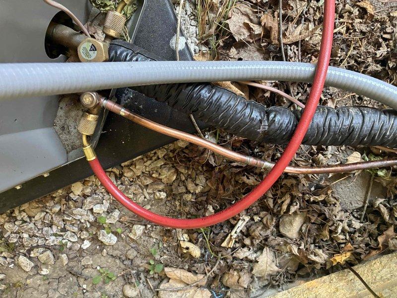 Responded to no-cooling call on recently installed AC system. Upon arrival, discovered outdoor unit not receiving power due to disconnected low-voltage control wiring at condenser. Reconnected thermostat wire to contactor, verified proper 24V signal, and tested system operation. Unit fired up successfully with compressor and condenser fan running normally. Confirmed adequate airflow at indoor air handler and proper temperature split across evaporator coil.