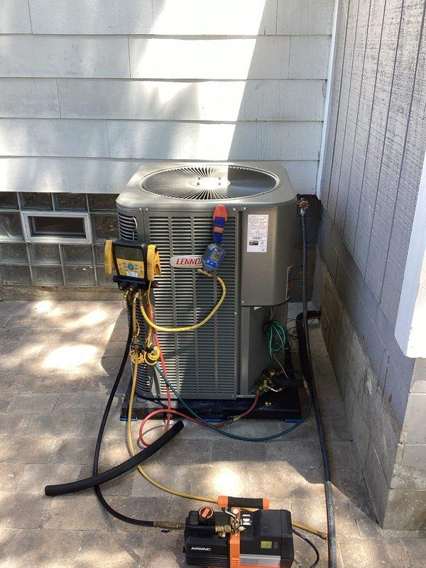 Completed installation of new Lennox air conditioning condenser unit on existing concrete pad against exterior wall. Connected refrigerant lines to previously installed evaporator coil and performed vacuum and leak test using manifold gauge set and vacuum pump. Charged system to manufacturer specifications and verified proper operation. Installed germicidal UV light system on air handler unit to improve indoor air quality. Tested all electrical connections, verified proper airflow, and confirmed system is cooling efficiently with no refrigerant leaks detected.