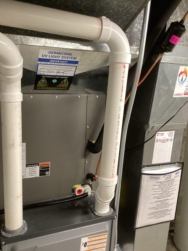 Completed installation of new Lennox air conditioning condenser unit on existing concrete pad against exterior wall. Connected refrigerant lines to previously installed evaporator coil and performed vacuum and leak test using manifold gauge set and vacuum pump. Charged system to manufacturer specifications and verified proper operation. Installed germicidal UV light system on air handler unit to improve indoor air quality. Tested all electrical connections, verified proper airflow, and confirmed system is cooling efficiently with no refrigerant leaks detected.