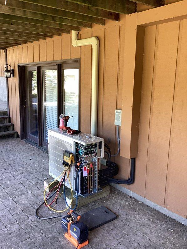 Completed installation of a 3-zone Mitsubishi ductless mini-split system at residential property. Mounted outdoor condensing unit on concrete pad in covered patio area with proper refrigerant line connections, electrical wiring, and PVC condensate drainage. Installed indoor wall-mounted air handler units in multiple zones including bedroom area, performed system startup, vacuum procedures, and refrigerant charging to manufacturer specifications.