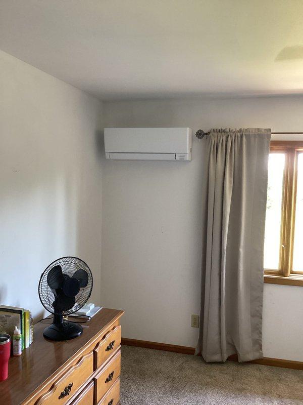 Completed installation of a 3-zone Mitsubishi ductless mini-split system at residential property. Mounted outdoor condensing unit on concrete pad in covered patio area with proper refrigerant line connections, electrical wiring, and PVC condensate drainage. Installed indoor wall-mounted air handler units in multiple zones including bedroom area, performed system startup, vacuum procedures, and refrigerant charging to manufacturer specifications.