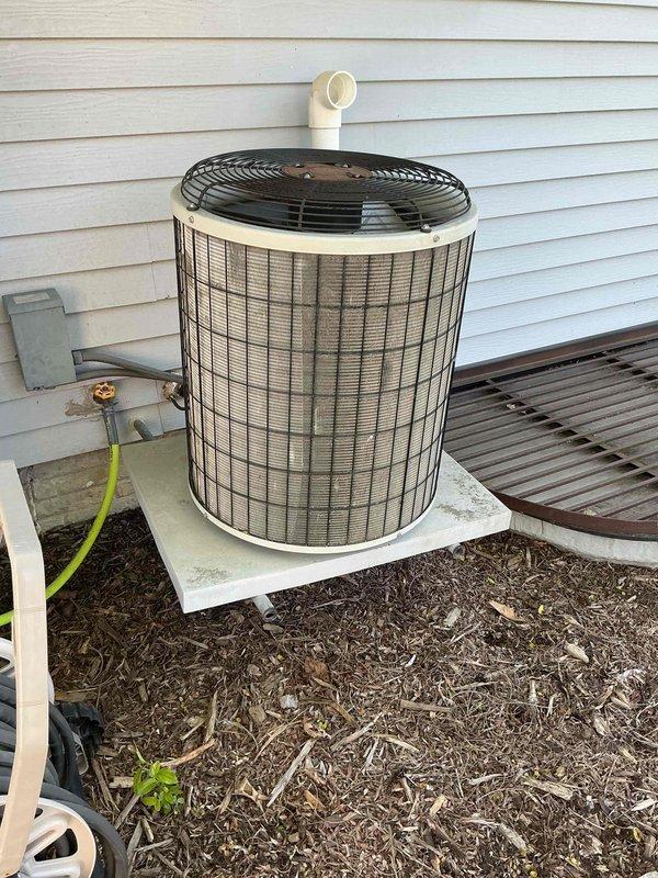 Completed comprehensive air conditioning tune-up on outdoor condenser unit. Performed visual inspection of heat exchanger coils, verified proper fin condition and spacing, checked refrigerant line connections, and documented equipment specifications. Unit found to be operating within normal parameters with all components in good working condition.