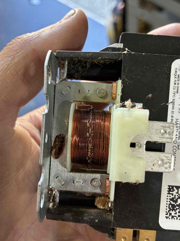 Responded to no-start condition on 4-year-old Lennox outdoor condensing unit. Upon inspection, discovered failed contactor coil showing visible heat damage and discoloration to copper windings. Replaced defective contactor, restored power to unit, and verified proper system operation with successful startup and normal cooling cycle.