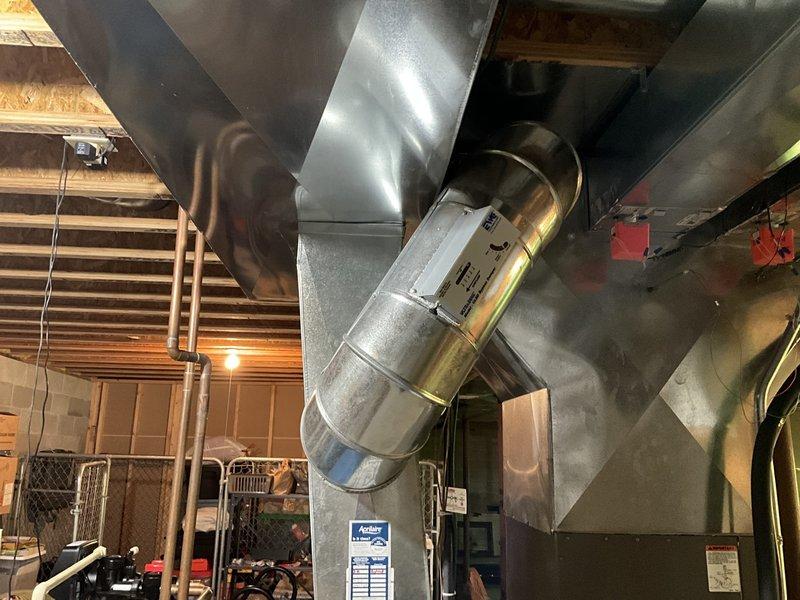 Conducted comprehensive assessment of 18-year-old Lennox zoned HVAC system located in basement. Evaluated existing furnace and air conditioning equipment, documented outdoor condenser unit condition showing weathering and algae growth on concrete pad, and inspected basement ductwork installation including UV air purification device and refrigerant lines. Provided replacement estimate with multiple equipment brand options to meet customer requirements for complete system upgrade.