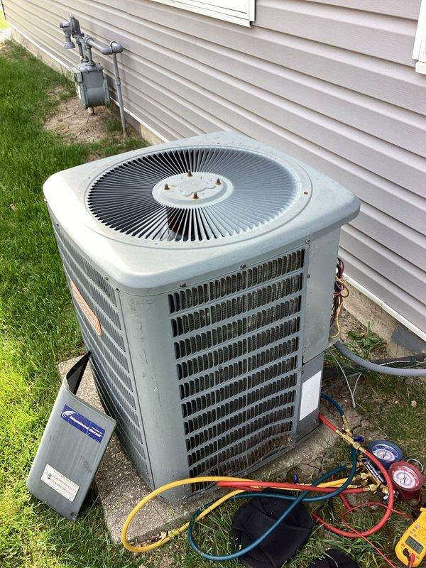 Responded to no cooling complaint on 10+ year old residential air conditioning system. Connected manifold gauges to condenser unit and performed refrigerant pressure diagnostics, revealing system operating outside normal parameters. Completed service evaluation and testing procedures to identify cooling failure cause.