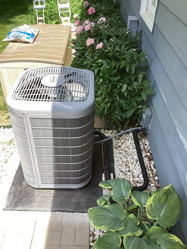 Returned to property to properly reposition outdoor condenser unit on pad. Verified unit orientation and confirmed all manufacturer labels and stickers on condenser remained visible and uncovered during installation process. Unit now correctly positioned on concrete pad with proper clearances maintained for airflow and service access.
