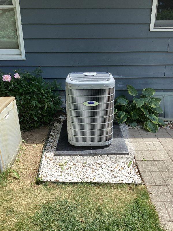 Returned to property to properly reposition outdoor condenser unit on pad. Verified unit orientation and confirmed all manufacturer labels and stickers on condenser remained visible and uncovered during installation process. Unit now correctly positioned on concrete pad with proper clearances maintained for airflow and service access.