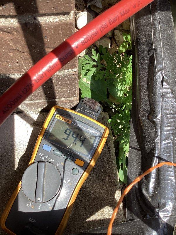 Completed AC system startup as part of new installation. Verified electrical readings using digital multimeter, confirming proper voltage at 99.4V to outdoor unit. Utilized manifold gauge set to check refrigerant pressures and system performance, ensuring all operating parameters met manufacturer specifications for optimal cooling operation.