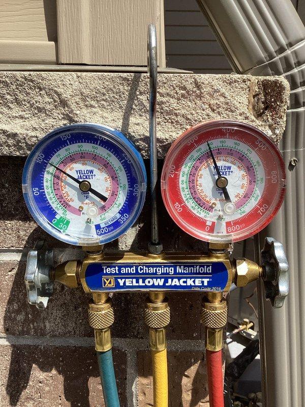 Completed AC system startup as part of new installation. Verified electrical readings using digital multimeter, confirming proper voltage at 99.4V to outdoor unit. Utilized manifold gauge set to check refrigerant pressures and system performance, ensuring all operating parameters met manufacturer specifications for optimal cooling operation.