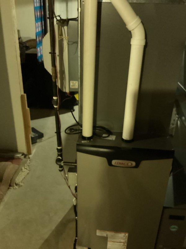 Completed full HVAC system installation including new Lennox furnace in basement utility area with proper PVC venting configuration and outdoor air conditioning unit. Performed system startup, refrigerant charging, and operational testing to verify proper performance of both heating and cooling components.