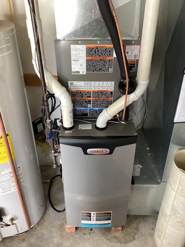 # HVAC System Installation

Successfully completed a full air conditioning system installation featuring a Lennox vertical air handler unit. The installation included mounting the air handler in the utility closet, establishing all refrigerant line connections with copper piping, and installing white PVC condensate drain lines to the top section of the unit. Electrical wiring was professionally routed and connected to power the system. All components were installed per manufacturer specifications and industry standards, with proper clearances maintained for future maintenance access. The installation site was left clean and organized, with all plumbing connections, drainage systems, and electrical work completed to code requirements.