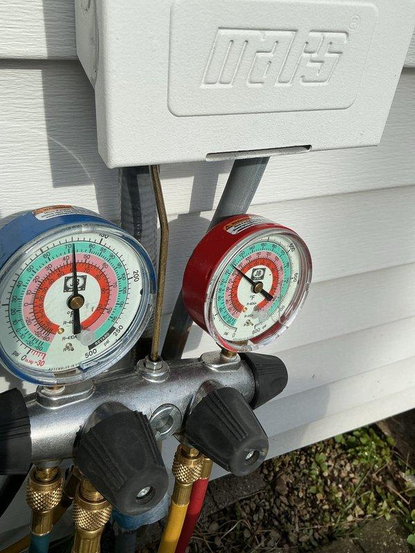 Responded to no cooling call on aging outdoor heat pump unit. Upon arrival, connected manifold gauge set to assess refrigerant pressures and system operation. Unit showed significant weathering with heavily rusted fan guard and evidence of extended outdoor exposure. Performed diagnostic evaluation of system pressures and overall equipment condition. Collected equipment information and documented unit condition with photos for customer records. Customer requested specific technician for follow-up service needs.