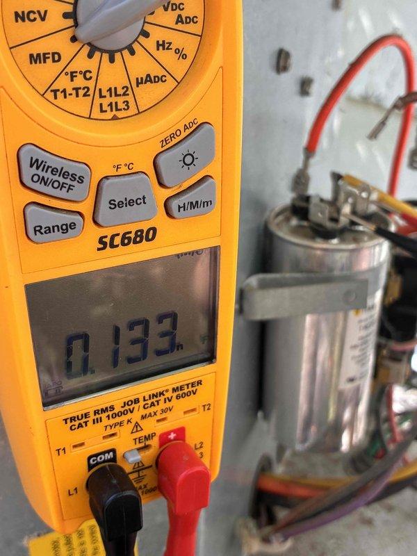 Responded to no cooling call where system had completely shut down. Upon arrival, verified electrical supply at breaker panel was intact. Performed diagnostic testing on outdoor unit and identified failed run capacitor. Tested capacitor with digital multimeter, confirming capacitance reading well below manufacturer specifications at 0.133 MFD. Replaced defective dual run capacitor, verified all electrical connections at compressor and condenser fan motor terminals, and restored system to normal operation with proper cooling.