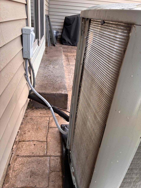 Completed seasonal A/C tune-up on outdoor condensing unit, performing standard preventative maintenance procedures including inspection of electrical connections, refrigerant levels, and condenser coil cleaning. Unit operational and running within normal parameters upon completion of service.