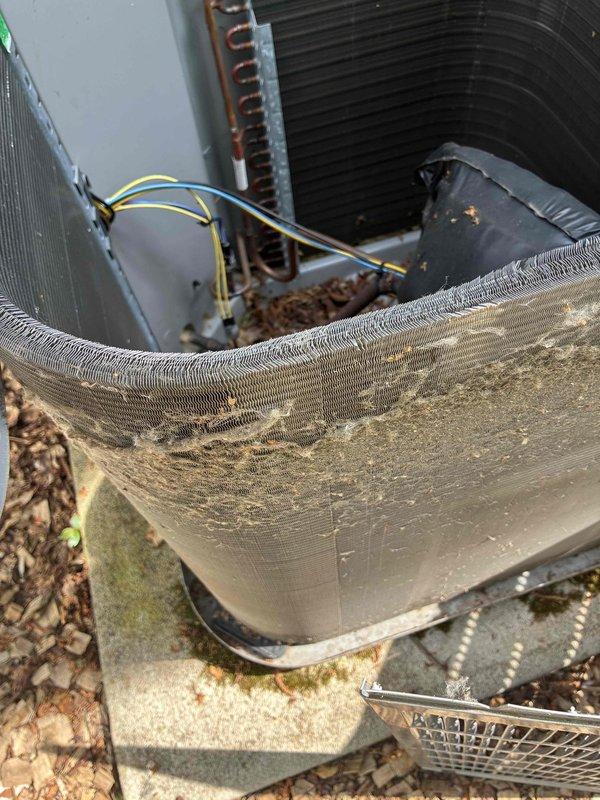 Completed scheduled cooling system maintenance visit as part of recurring membership agreement. Performed comprehensive inspection of outdoor condensing unit, which revealed heavy accumulation of dirt, dust, and debris on exterior housing and condenser coil fins. Noted significant environmental buildup affecting airflow efficiency, with brownish-tan discoloration visible across fin assembly and exterior panels. Inspected refrigerant lines, electrical connections, and internal components including capacitor and wiring. Unit mounted on concrete pad with evidence of extended outdoor exposure and weathering requiring attention to maintain optimal system performance.