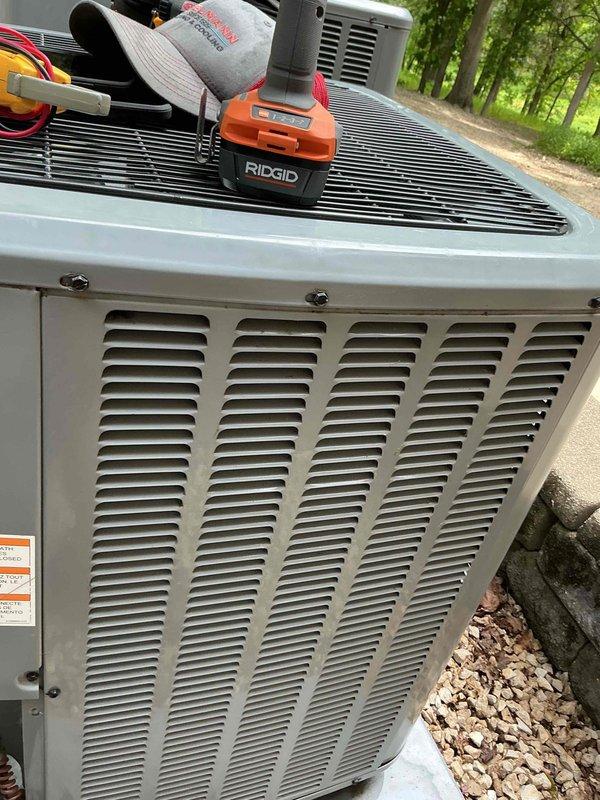 Completed tune-up service on residential outdoor air conditioning unit. Performed standard diagnostic testing including electrical measurements, with multimeter readings confirming proper voltage levels at 501V. Unit operating within normal parameters with no issues identified.