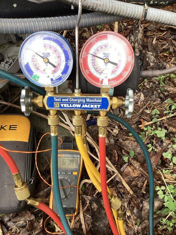 # HVAC Service Completed

Responded to a no cooling call with system failure indication. Upon arrival, performed diagnostic evaluation of the outdoor condensing unit. Inspected electrical control panel and internal components including the Totaline dual run capacitor, control boards, and associated wiring connections.

Utilized Yellow Jacket manifold gauge set to check refrigerant pressures and system operating parameters. Tested electrical components with multimeter to verify proper voltage and continuity. All wiring connections were found intact and properly terminated to capacitor terminals and control boards.

Identified system failure cause and restored cooling operation. Unit tested and confirmed operational at time of departure.